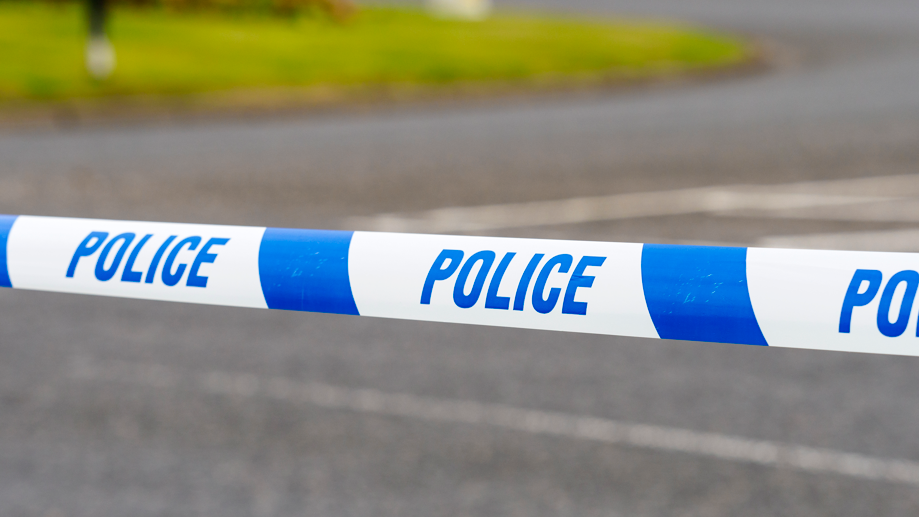 A blue and white striped police tape with the word police written on it in blue lettering