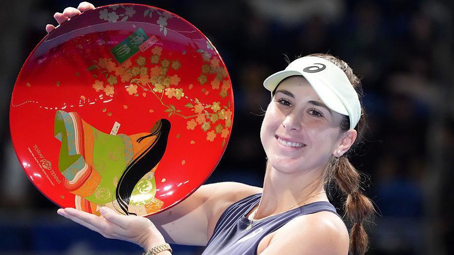 Belinda Bencic of Switzerland poses with the trophy