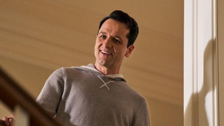 Matthew Rhys as Nile Jarvis in The Beast In Me peers down the staircase