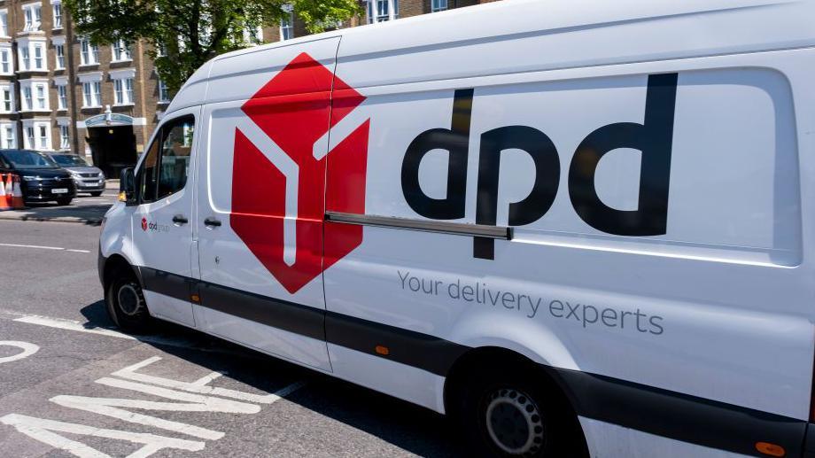 A DPD van pulling out into the road on a sunny day with houses visible in the background  