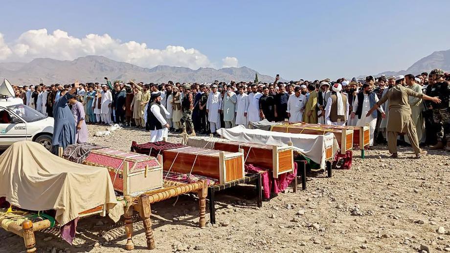 Sunni Muslim men offer prayers during the funeral ceremony for victimsof a a tribal clash in Kurram district on 13 October 2024.