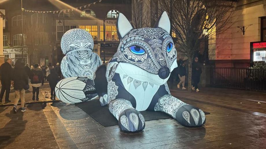 One of the attractions at the light festival - a giant inflatable fox with blue eyes and an ornate design on the head.