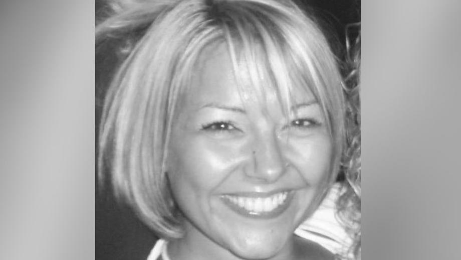 A black-and-white picture of Claire Wealleans smiling at the camera.