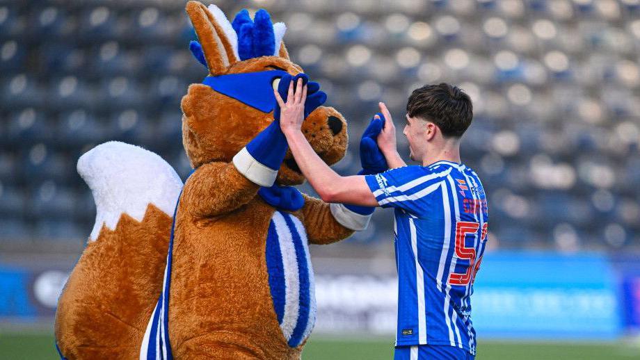 Findlay Curtis celebrates with Kilmarnock mascot Captain Conker