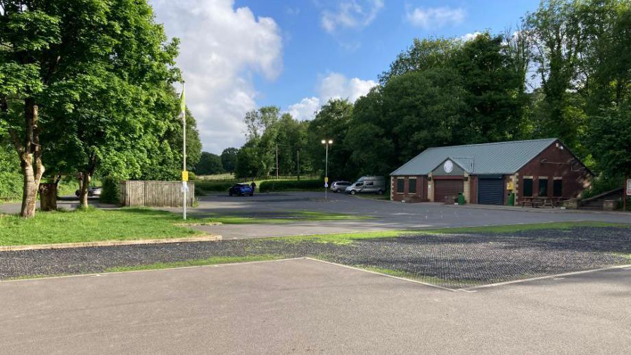 The empty car park at Yarrow Vale Country Park in Chorley. The photograph was taken on a bright sunny day.