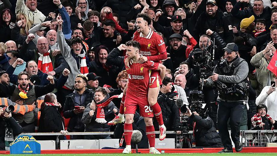 Diogo Jota celebrates with Liverpool team-mate Curtis Jones on his back after scoring the winner against Everton in April 2025