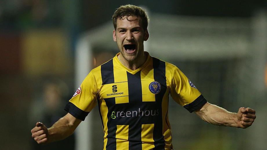 Mickey Demetriou, pictured celebrating a goal, won promotion from League Two with Shrewsbury Town