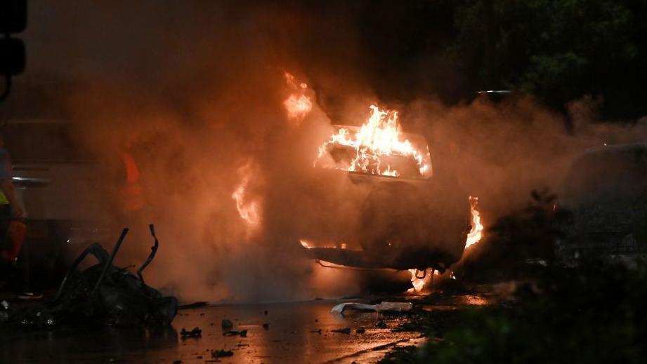 A firefighter works on the site of an explosion which occured near Karachi airport in Karachi