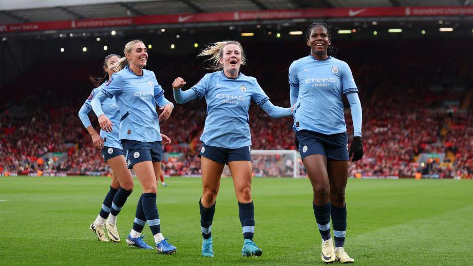 Khadija Shaw celebrates scoring a goal with team mates.