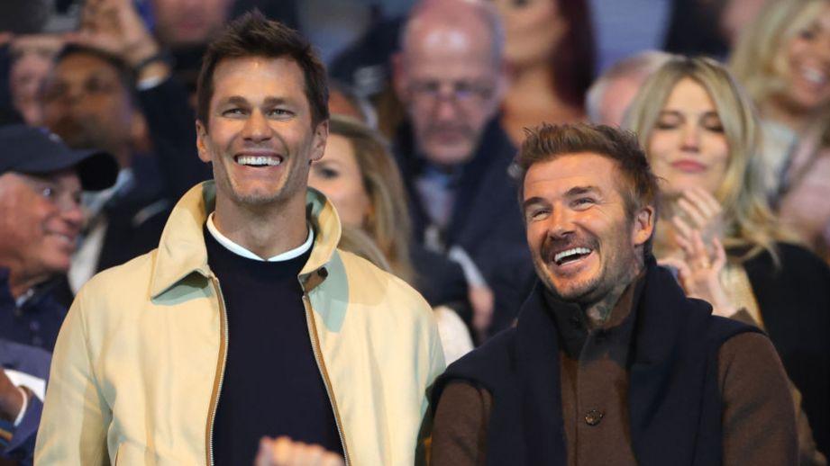 Former NFL quarterback Tom Brady (L) with ex-England international David Beckham