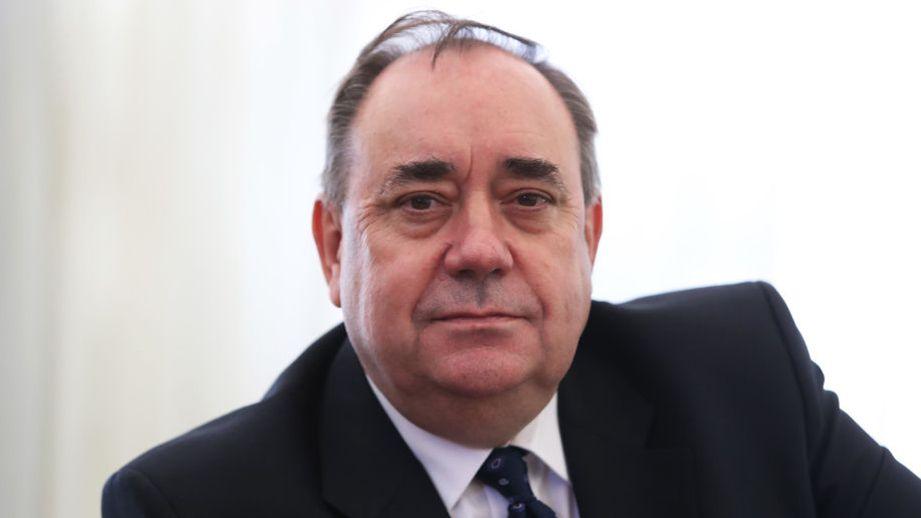 Alex Salmond in a dark suit and tie looking at the camera