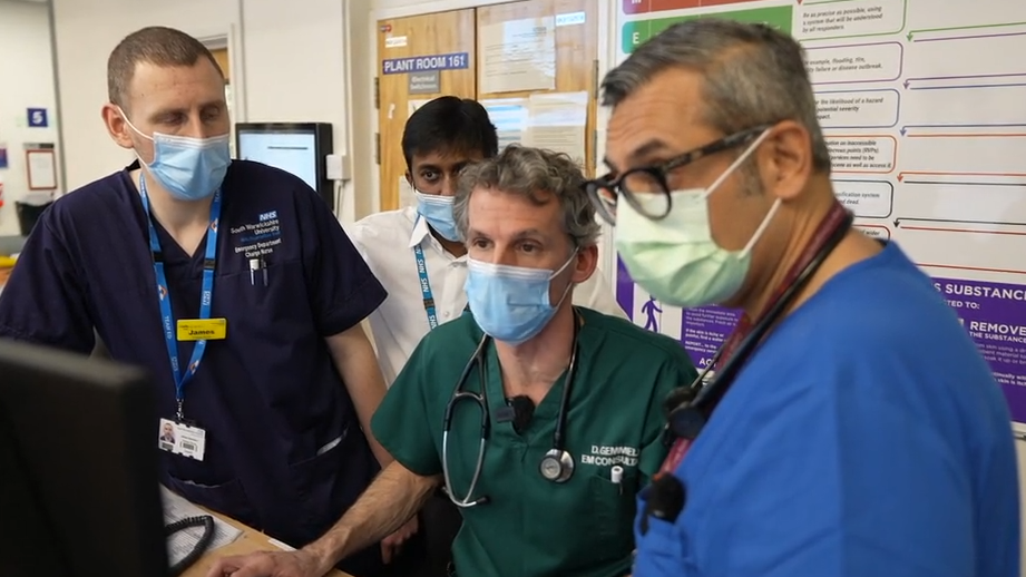 Dr Raj Paw (in light blue) and colleagues look at computer statistics assessing the hospital's capacity