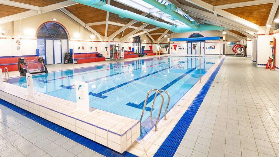 A four-lane indoor swimming pool.