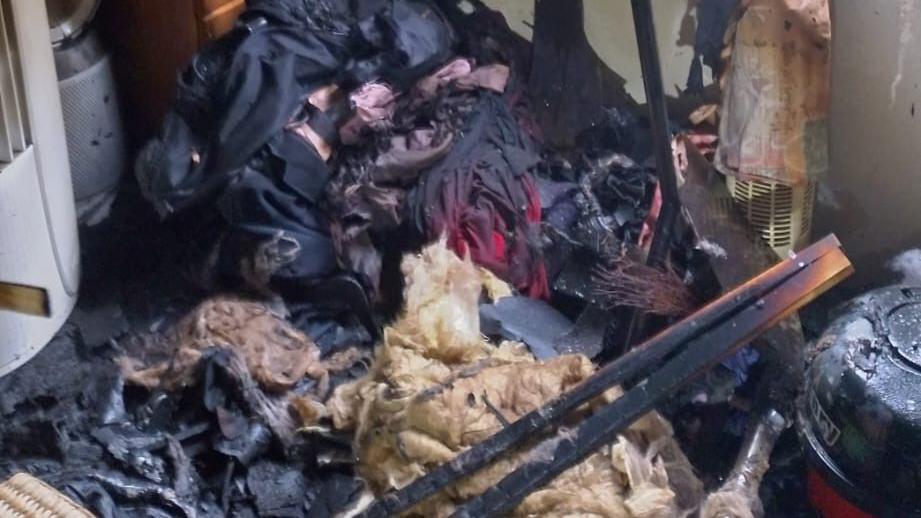 A pile burnt clothing and items inside the caravan