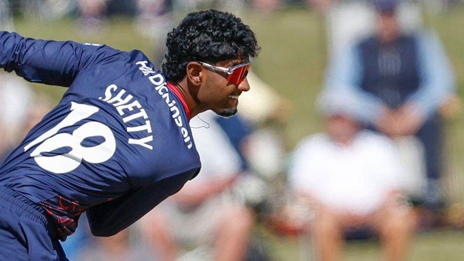 Arav Shetty bowls wearing a blue Lancashire kit