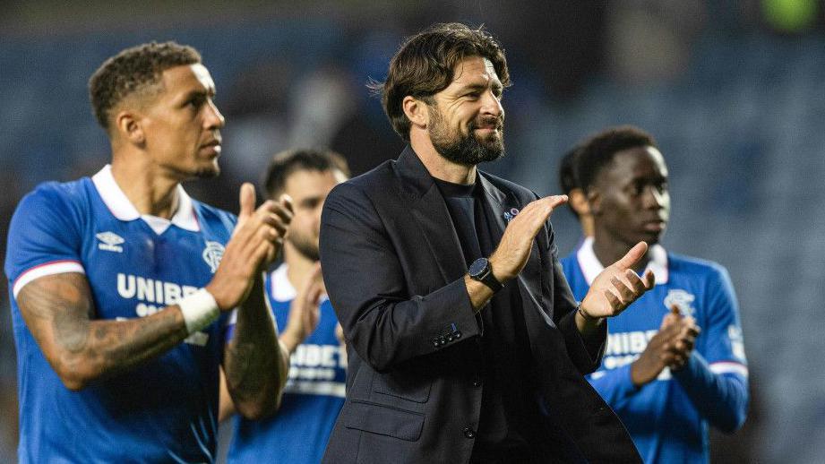 Rangers head coach Russell Martin applauds fans at Ibrox
