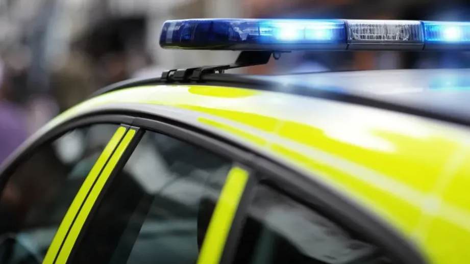 A close up of a police car's siren and reflective material on the roof