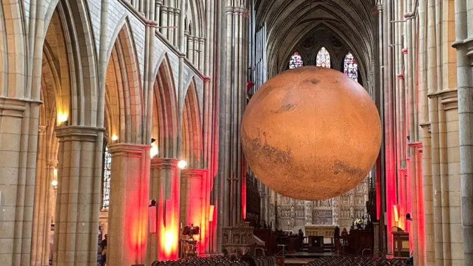 A large red planet seen in a church setting.