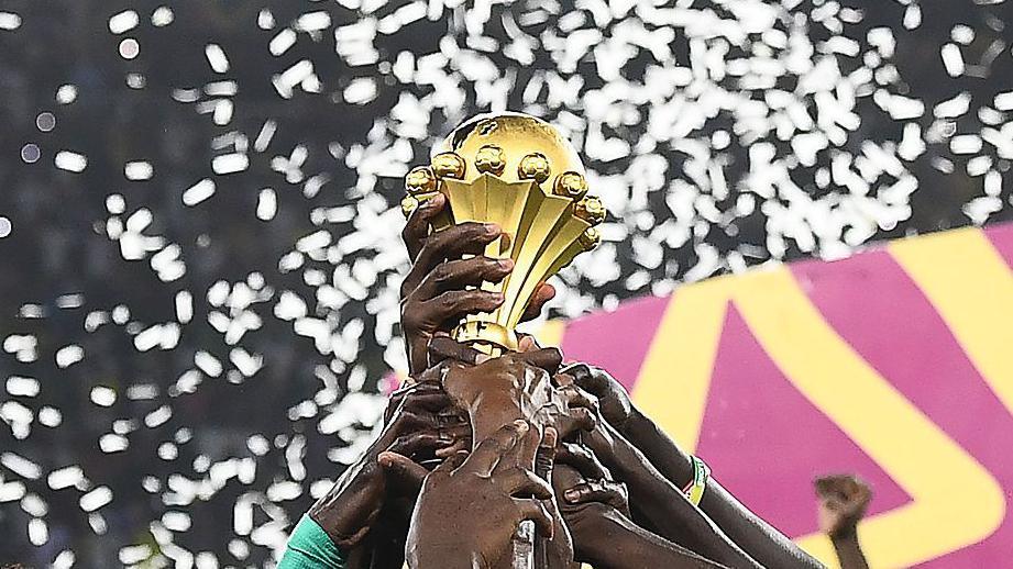 Senegal's players hold the trophy after winning the Africa Cup of Nations 2021 final.
