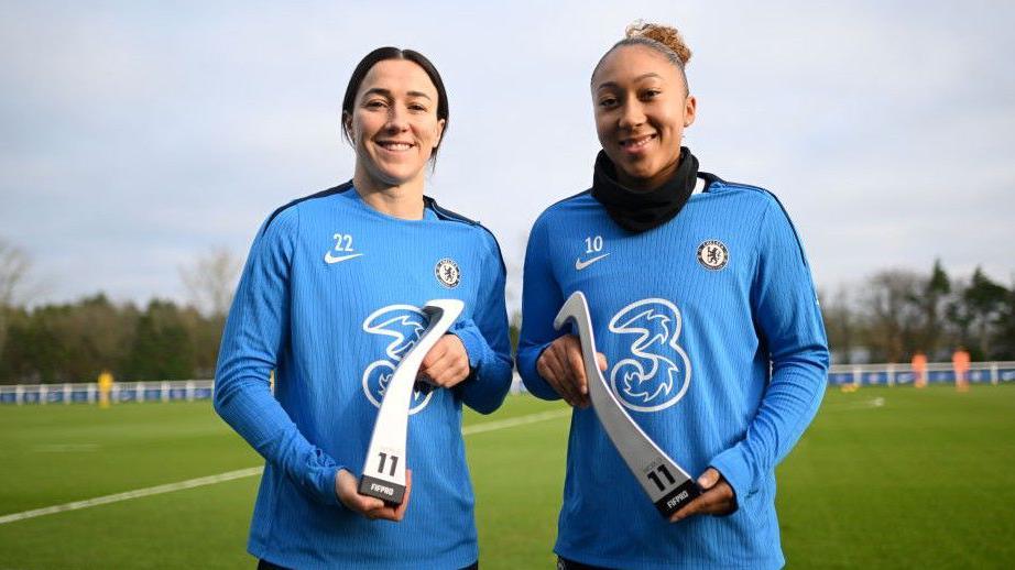 Chelsea's Lucy Bronze (left) and Lauren James (right) hold up their Fifpro World XI trophies to the camera.