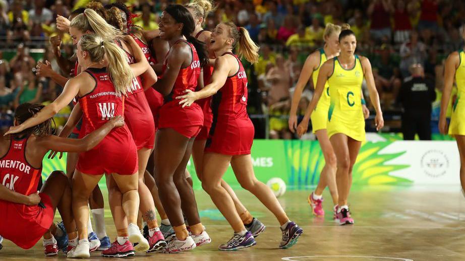 England's netball team celebrate while Australia look dejected