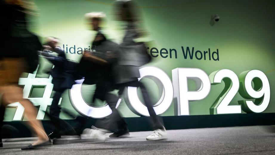 people rushing past a cop 29 logo