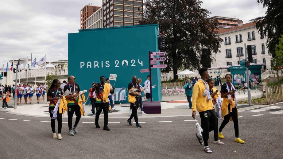 athletes walking in the Olympic Village in Paris. 