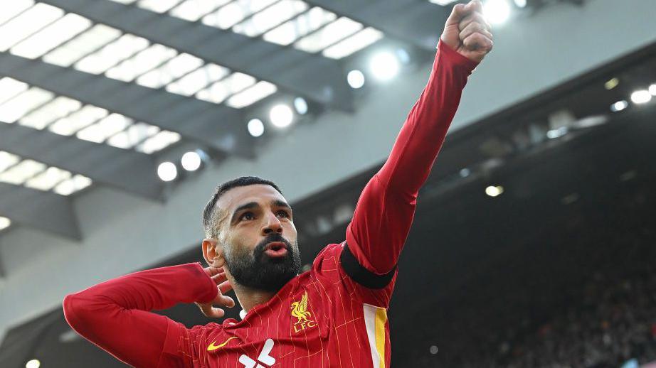 Mohamed Salah celebrates after his penalty set Liverpool on their way to victory over Chelsea at Anfield