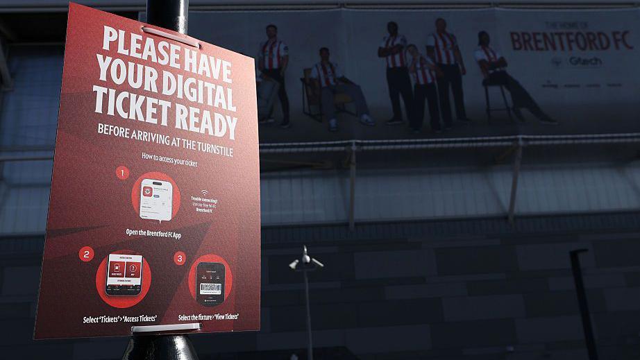 A sign outside the stadium asking fans to have their digital ticket ready