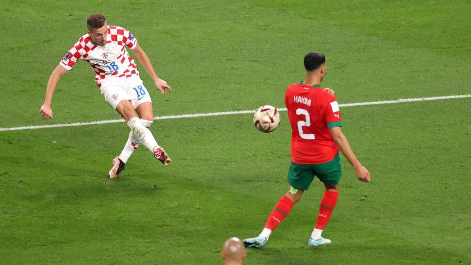 Mislav Orsi strikes the ball for the winner of Croatia's victory over Morocco