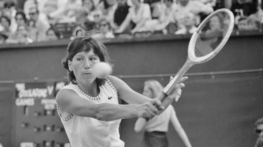 Olga Morozova hits the ball with a wooden racquet at Queen's