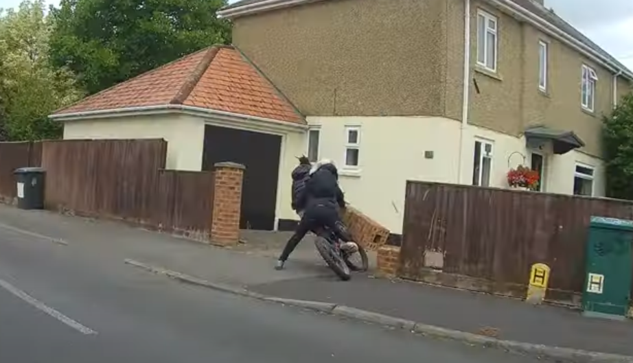 Two people on an e-bike colliding with a wall