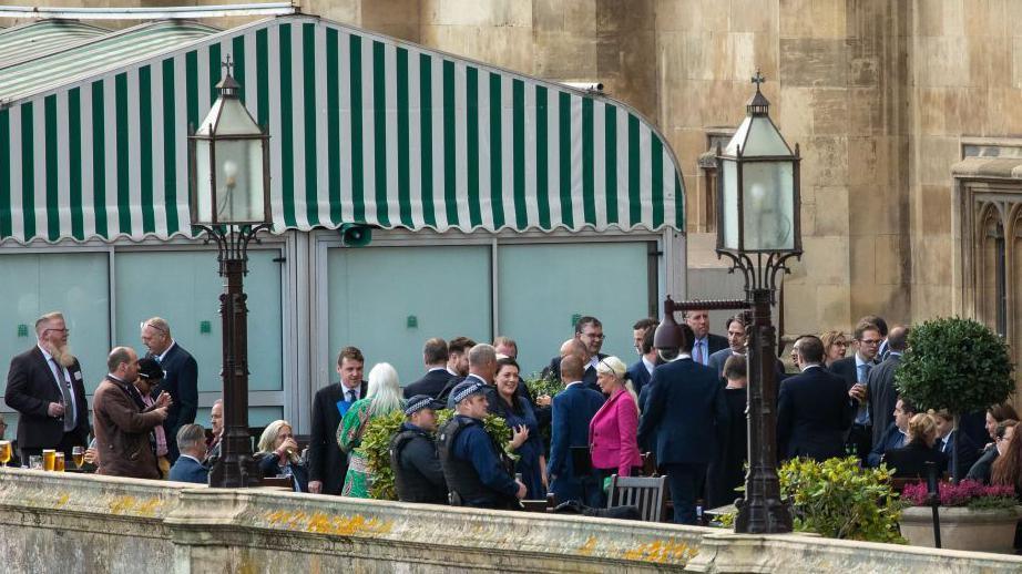 Conservative MPs take refreshments on the terrace outside the House of Commons after Rishi Sunak won the Conservative leadership contest on 24 October 2022 