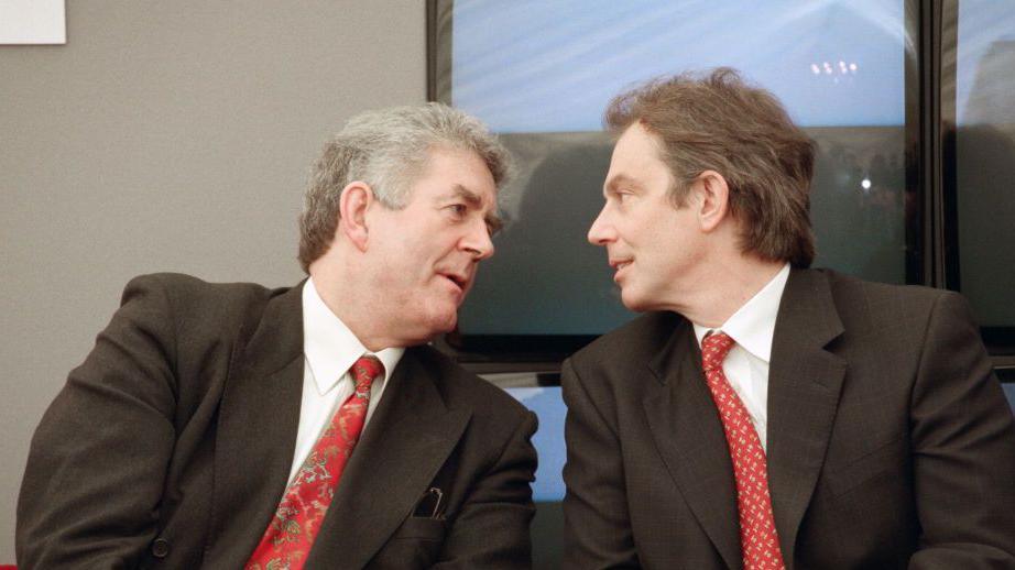 Rhodri Morgan and Tony Blair, both wearing suits, engaged in conversation