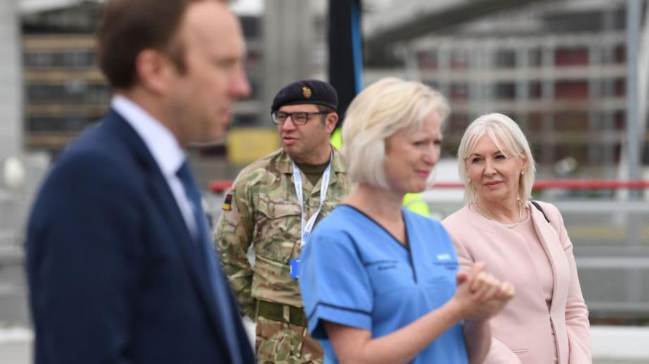 Photograph of Ruth May alongside Matt Hancock and Nadine Dorries in April 2020.