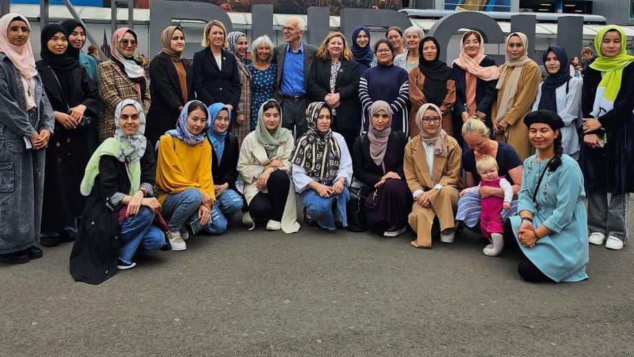 Students with politicians and members of the Linda Norgrove Foundation