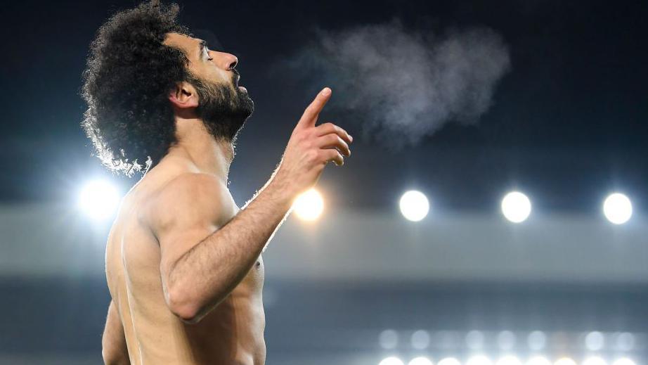 Mohamed Salah celebrates scoring for Liverpool against Manchester United by praying