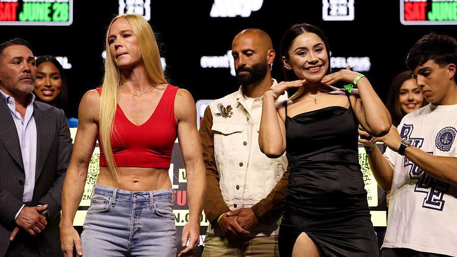 Holly Holm and Yolanda Guadalupe Vega Ochoa pose for pictures at a news conference