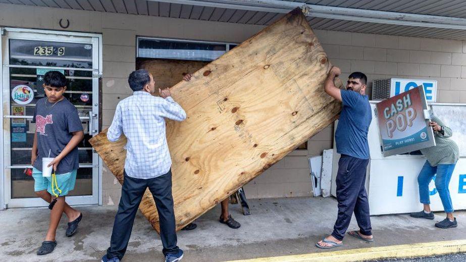 People cover windows with plywood as the town prepares for Hurricane Helene in Mayo, Florida, USA, 26 September 2024. 