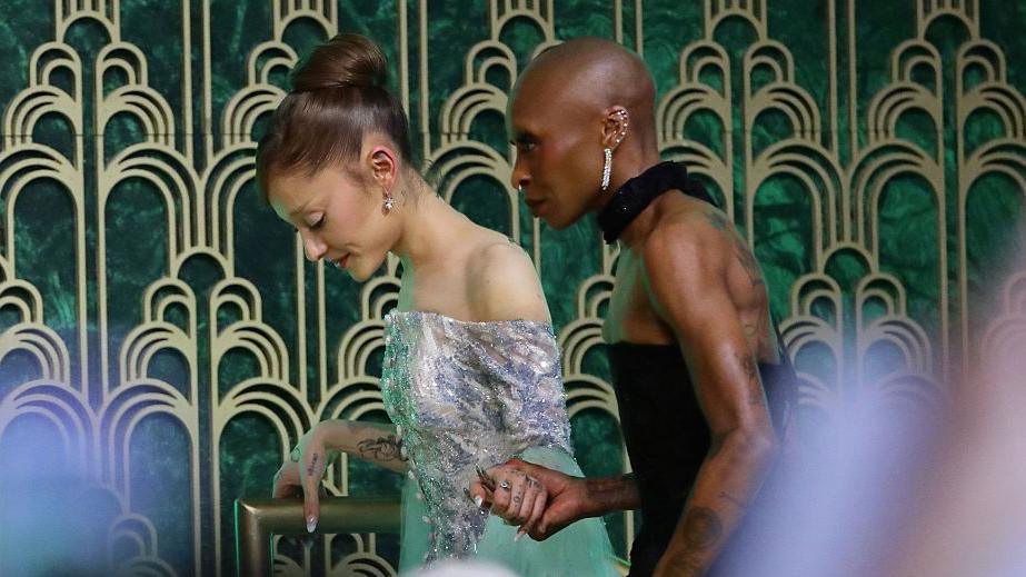 Ariana Grande and Cynthia Erivo seen here holding hands as they walk off 