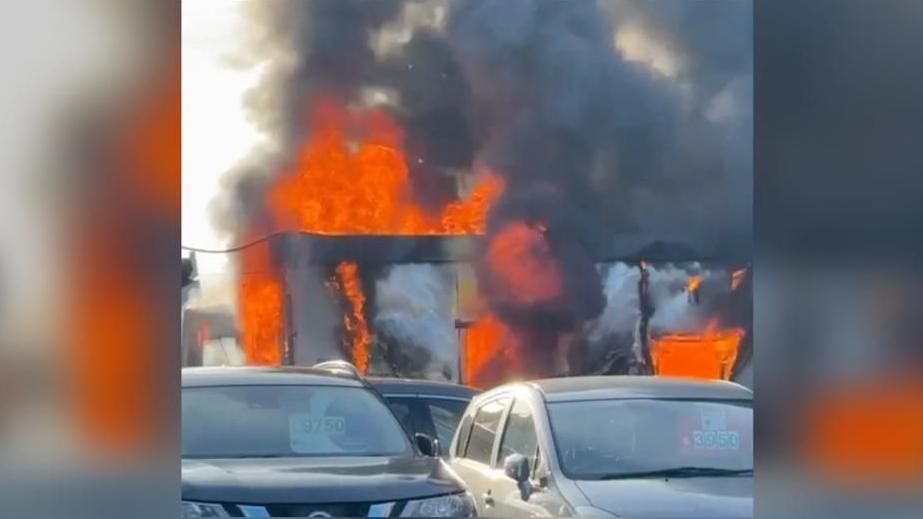 Commercial unit alight behind a row of cars, in Bognor Regis, West Sussex