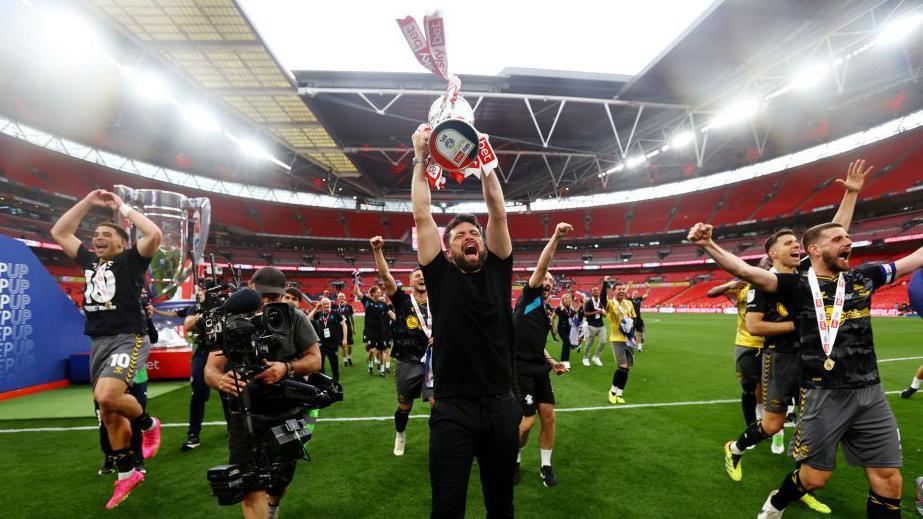 Southampton manager Russell Martin lifts the trophy after winning the Sky Bet Championship Play-Off Final match between Leeds United and Southampton FC at Wembley Stadium on 26 May 2024