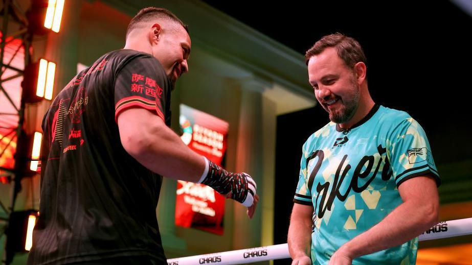 Joseph Parker smiles with trainer Andy Lee during an open workout