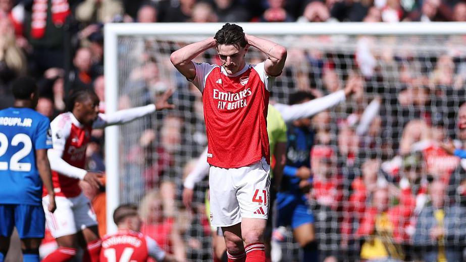 Declan Rice with his hands on his head. 