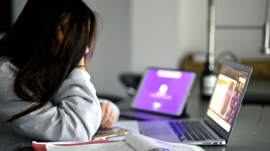 A girl starts her Zoom lesson as homes chooling continued due to school closures during the Covid-19 pandemic in 2021. 