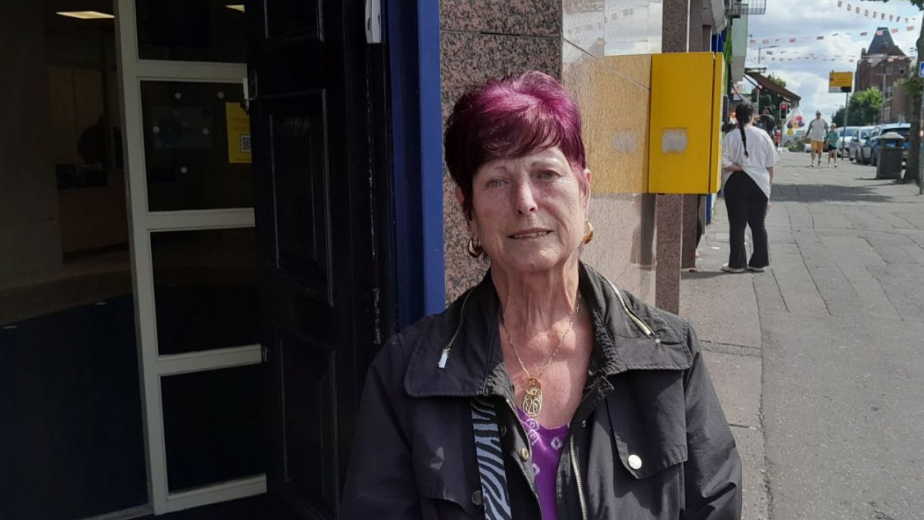 Sandra Wadsworth, standing on the Shankill Road