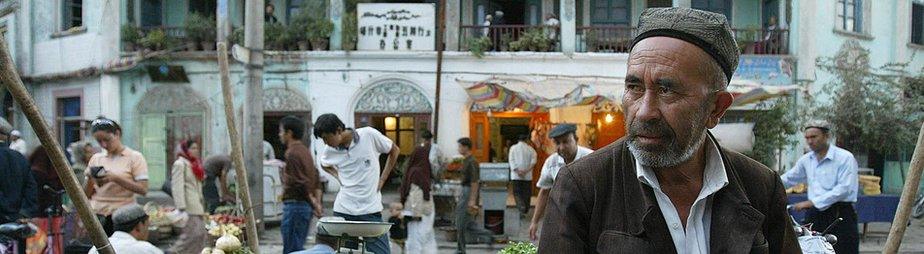 An Uighur man minding a fruit stand in Kasghar, file pic from 2003