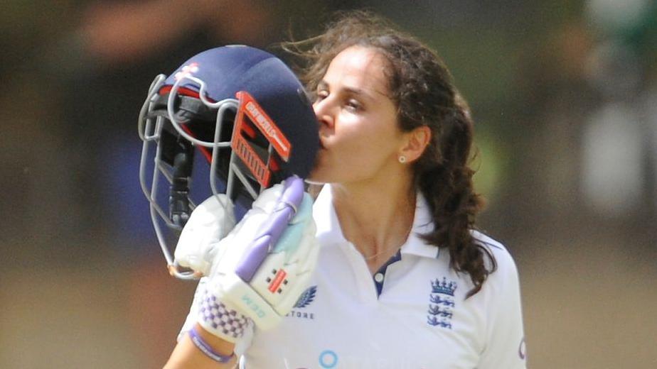 England's Maia Bouchier kisses the badge on her helmet after reaching a century on her Test debut against South Africa