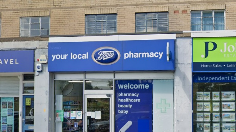 A small Boots store with a travel agent on one side and estate agent on the other 