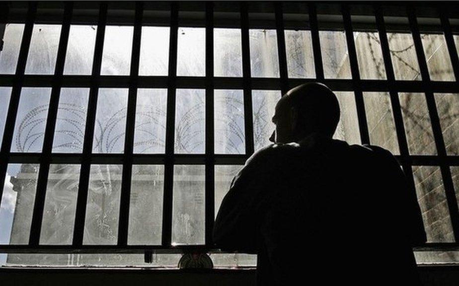 An inmate looking out from prison